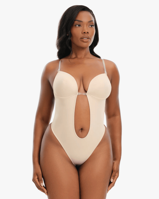 Woman wearing a beige one-piece swimsuit on a white background