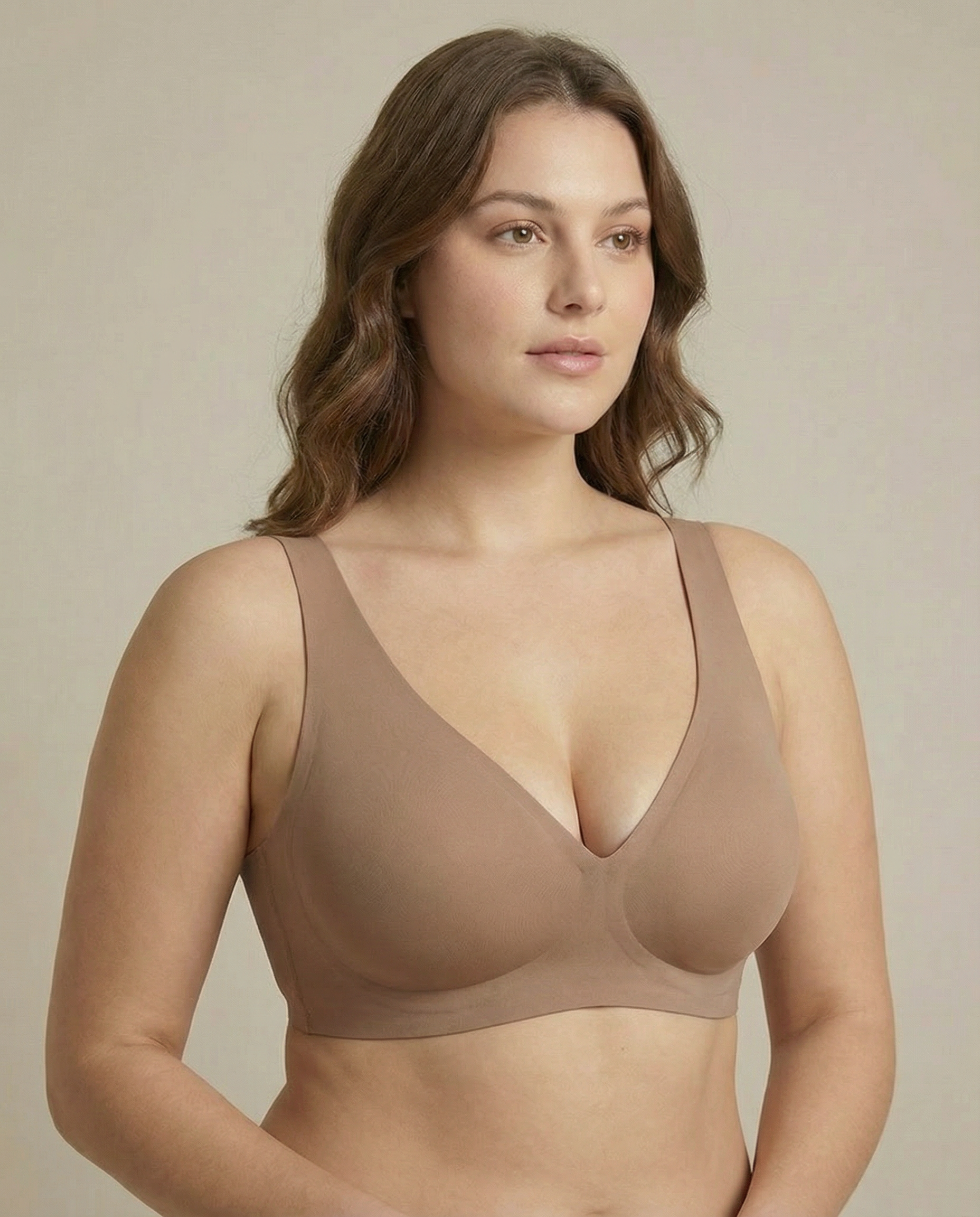 Woman wearing a beige bra against a neutral background