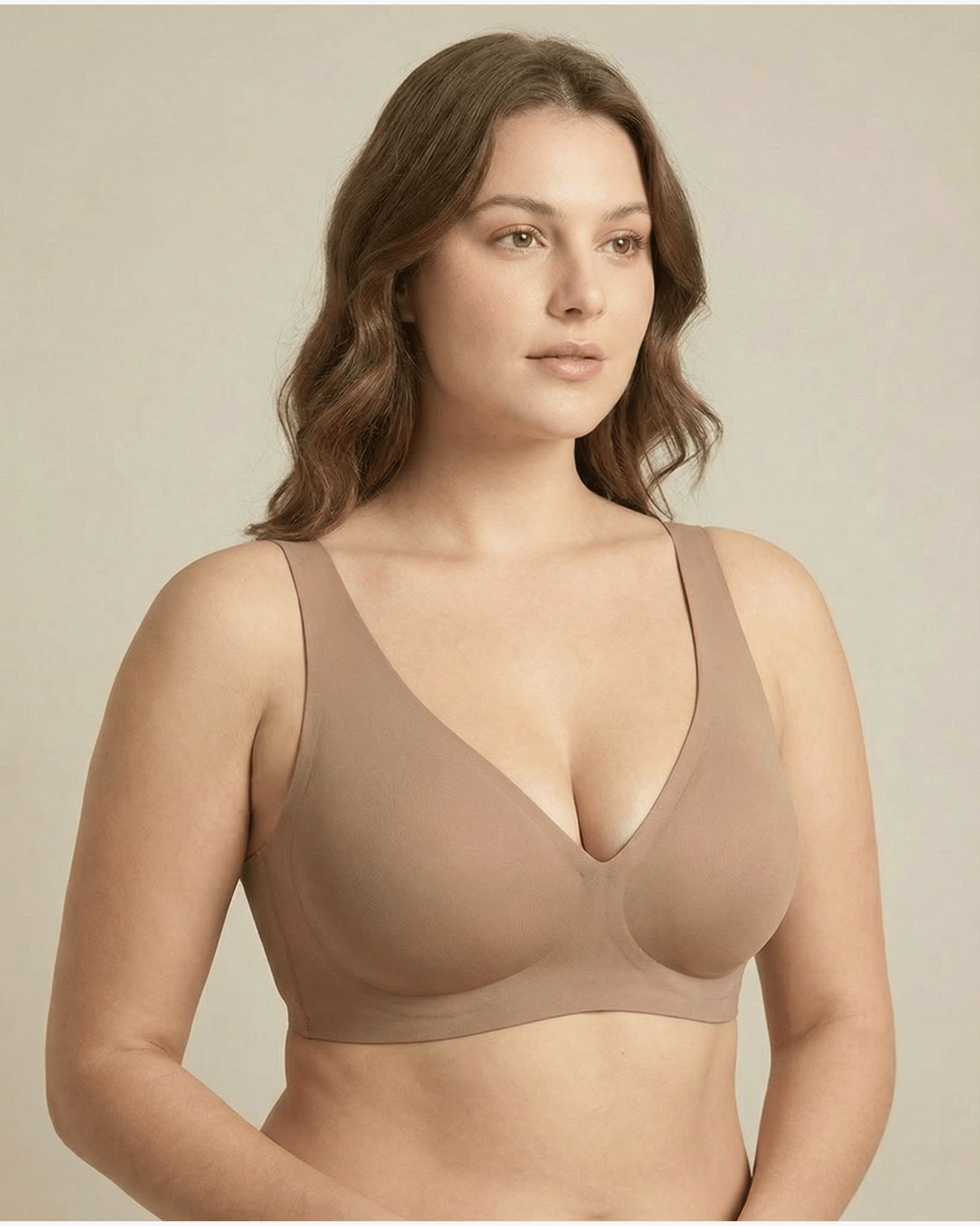 Woman wearing a beige bra against a neutral background