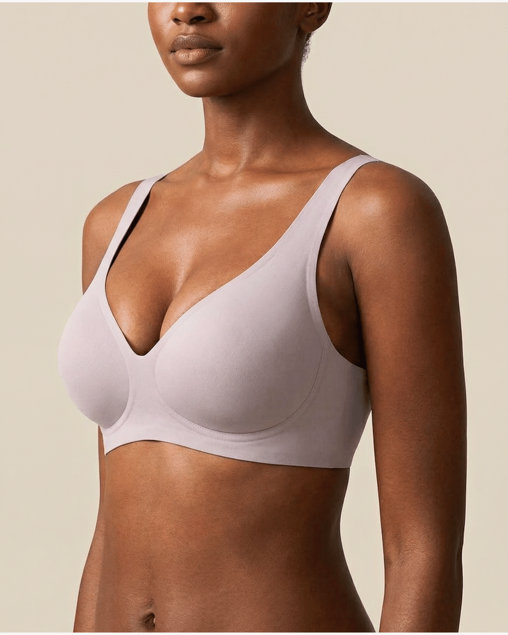Light purple bra worn by a model on a beige background