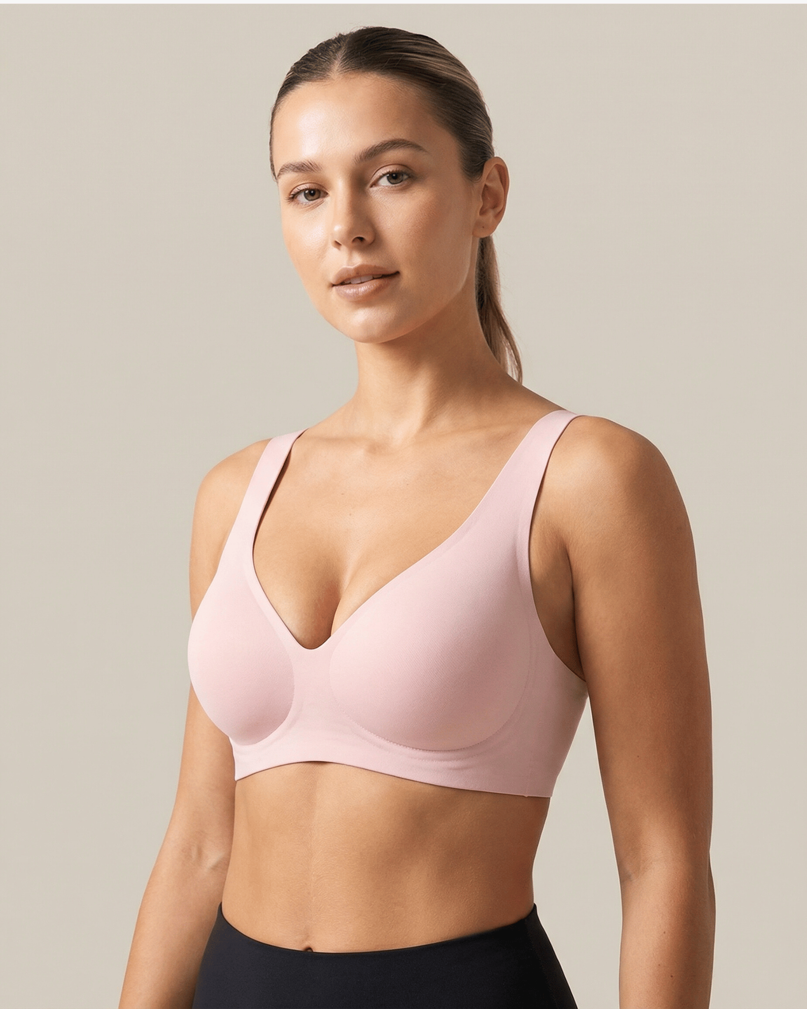 Woman wearing a pink sports bra against a neutral background
