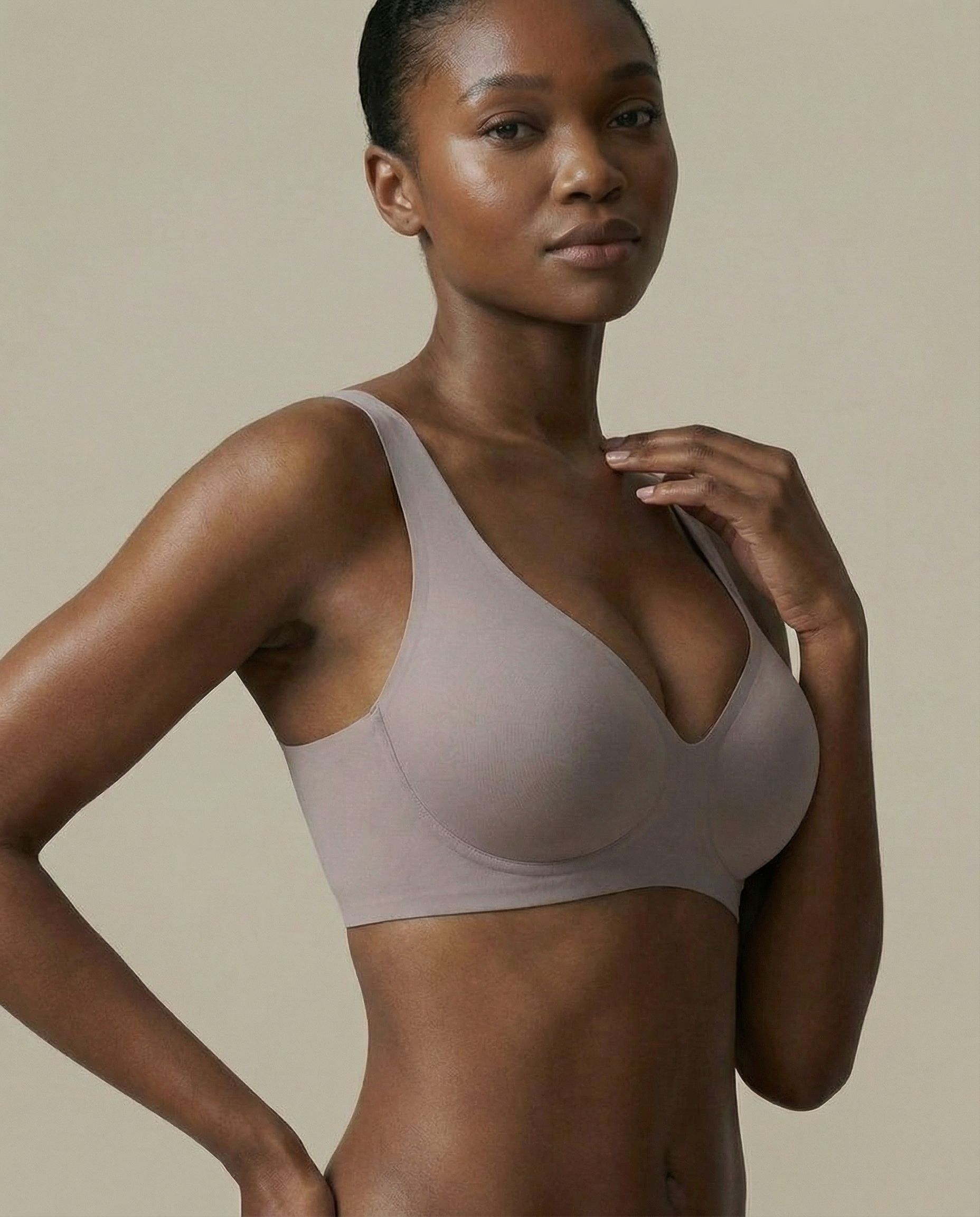 Woman wearing a beige bra against a neutral background