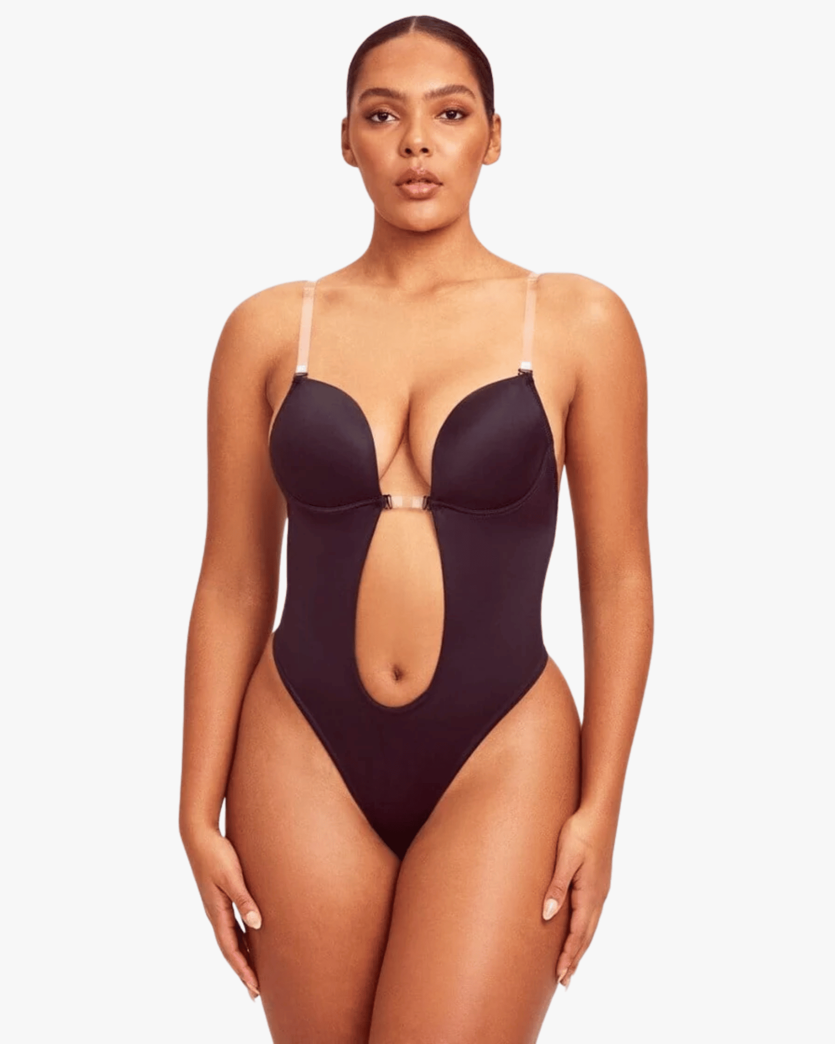 Woman wearing a black swimsuit with cut-out design on a white background