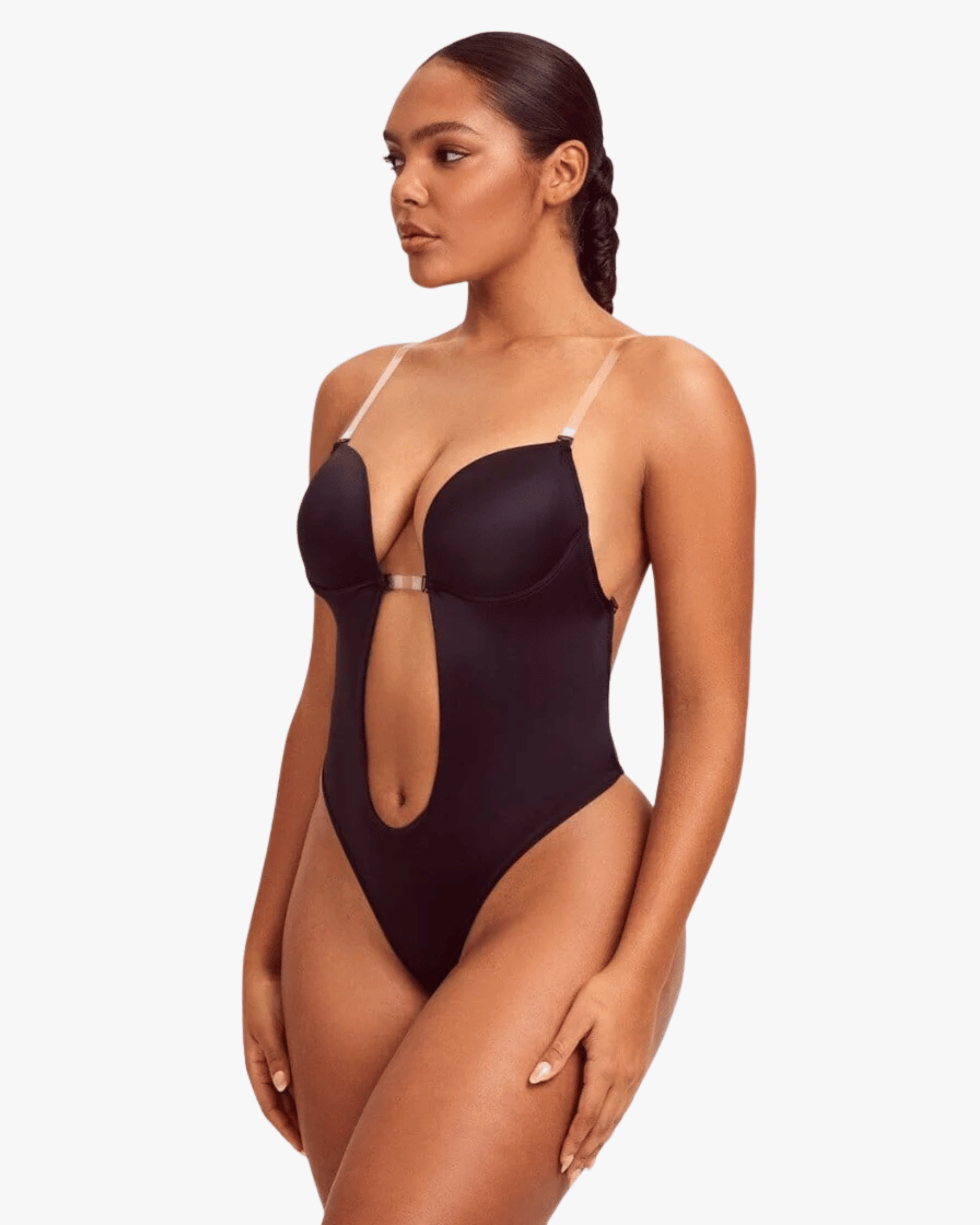 Woman wearing a black swimsuit with cut-out design on a white background