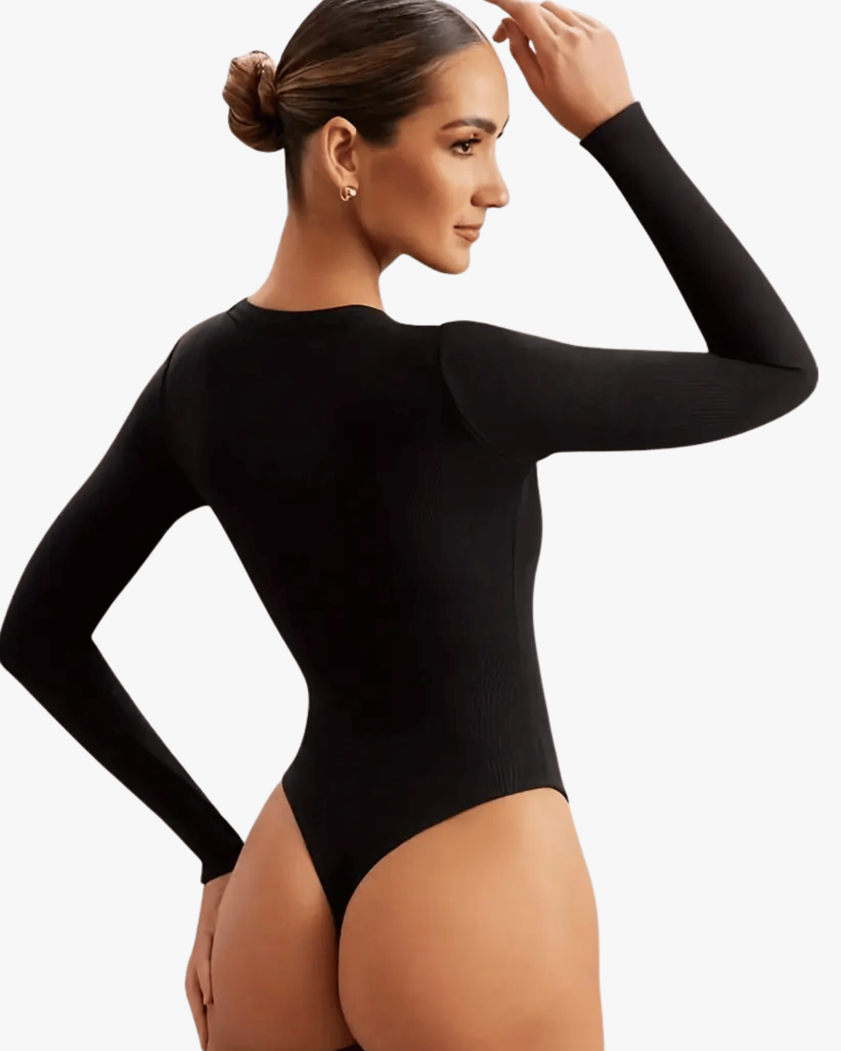 Woman wearing a black long-sleeve bodysuit on a plain background