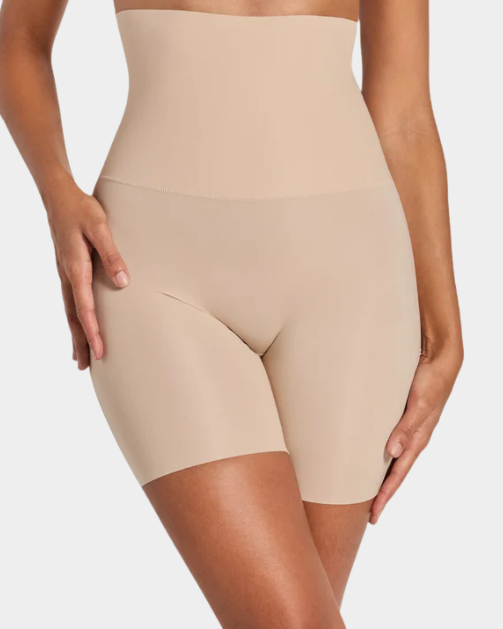 Beige shapewear shorts worn by a person on a plain background