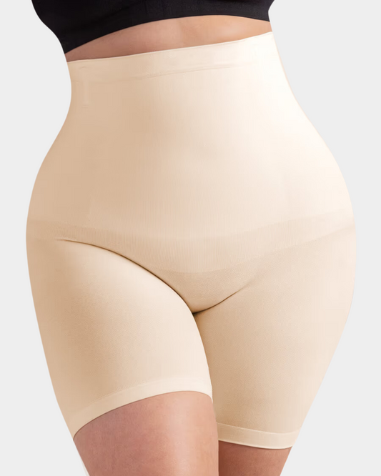 Beige shapewear shorts worn by a person on a light gray background