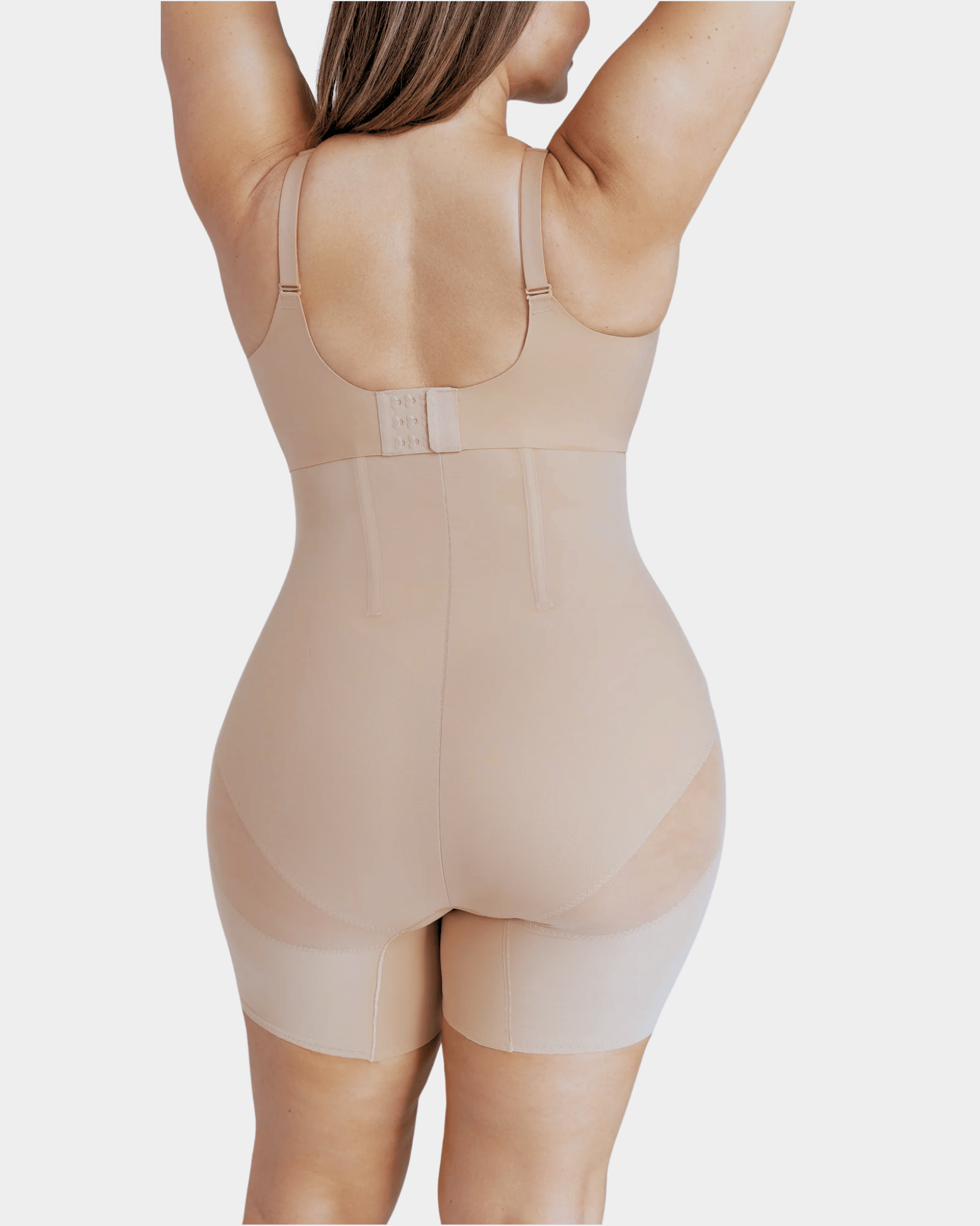 Beige shapewear garment worn by a person on a light gray background