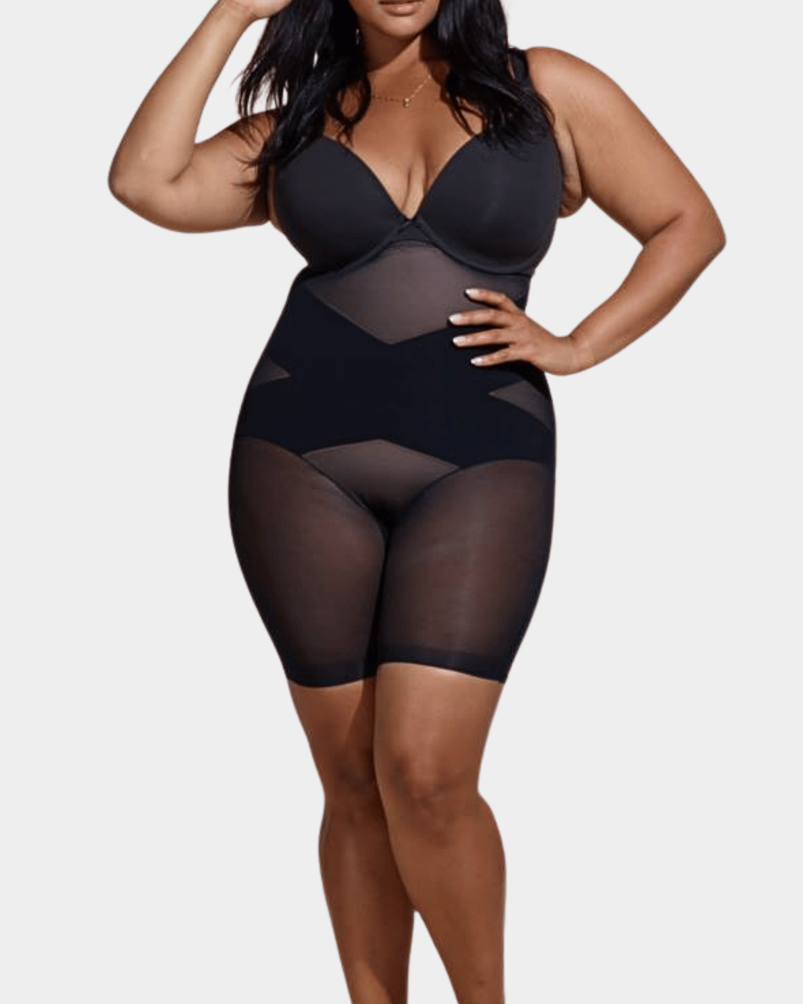Black mesh bodysuit worn by a model on a white background